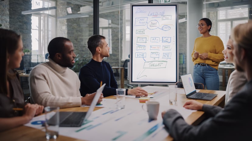 Project Manager Makes a Presentation for a Team in Meeting Room in an Agency