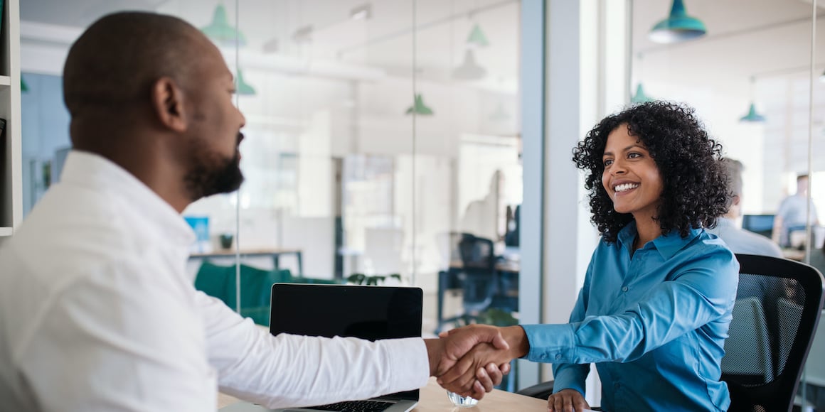HR manager shaking hands with candidate after job interview