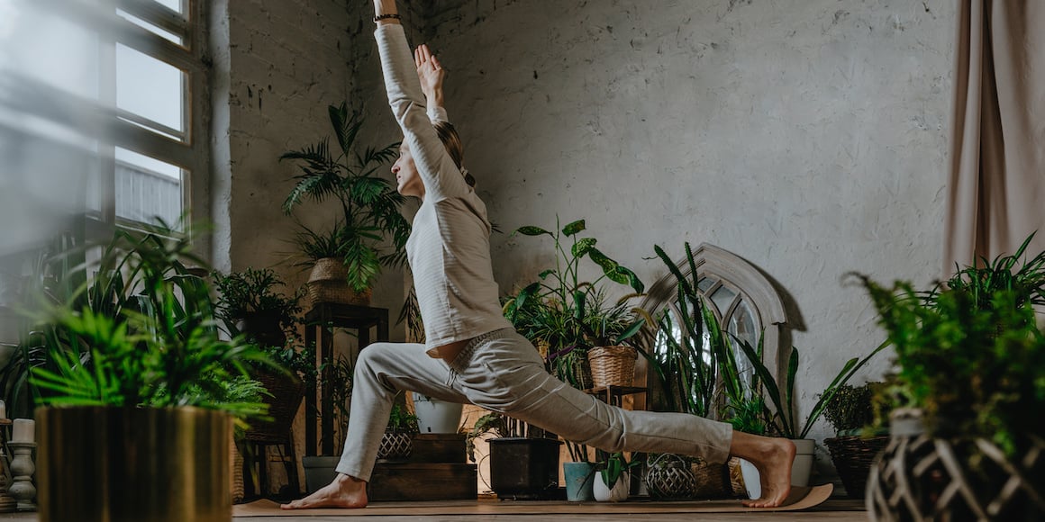 Student doing yoga warrior pose for mental health wellness